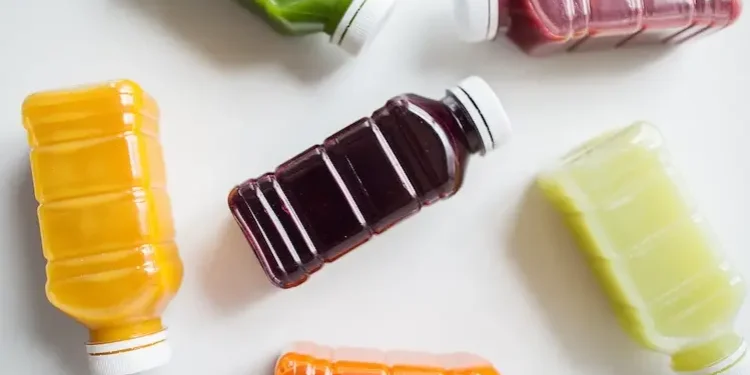 Juice bottles on white table.